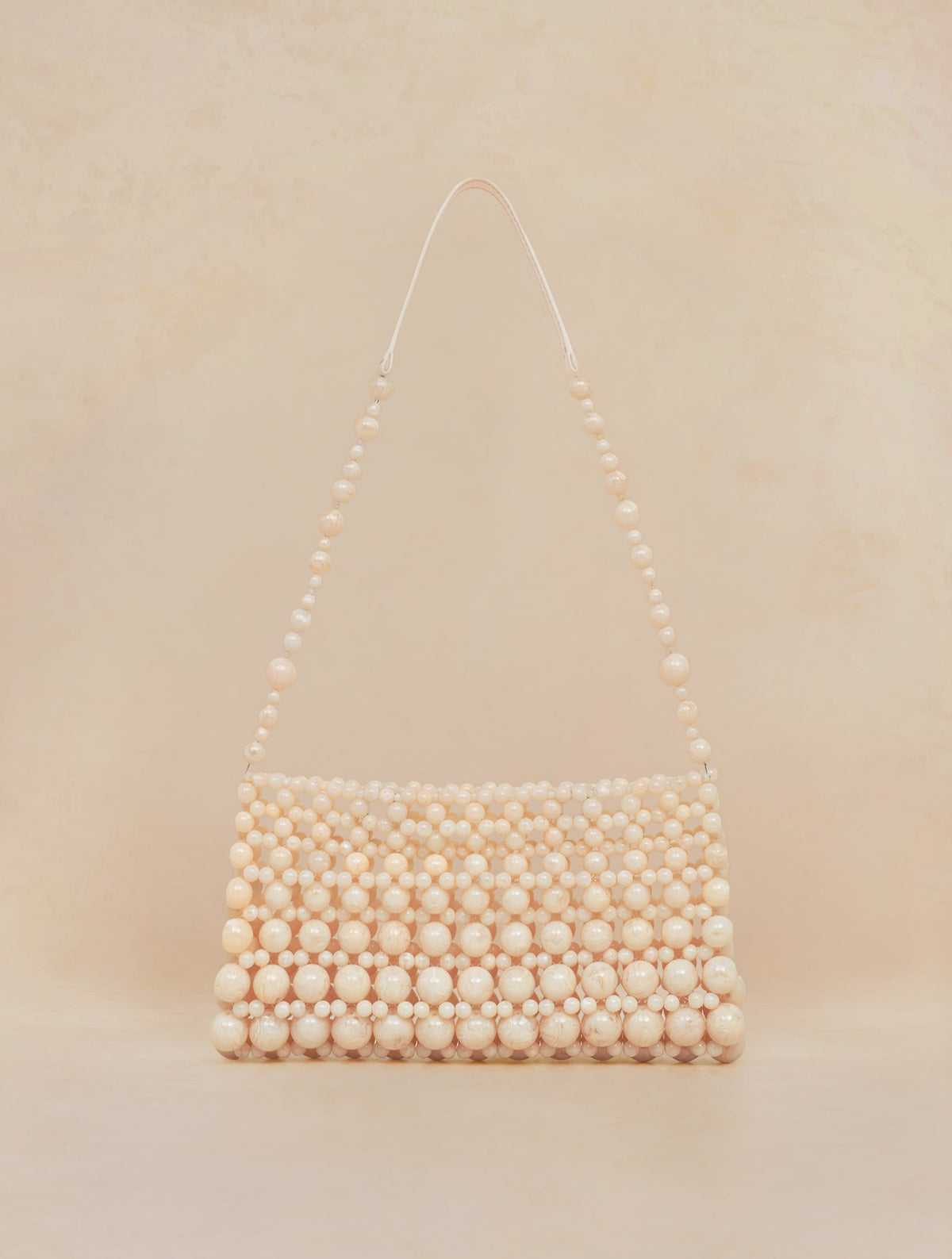 Bobbies Deià Ivory handbag — product view on warm studio background