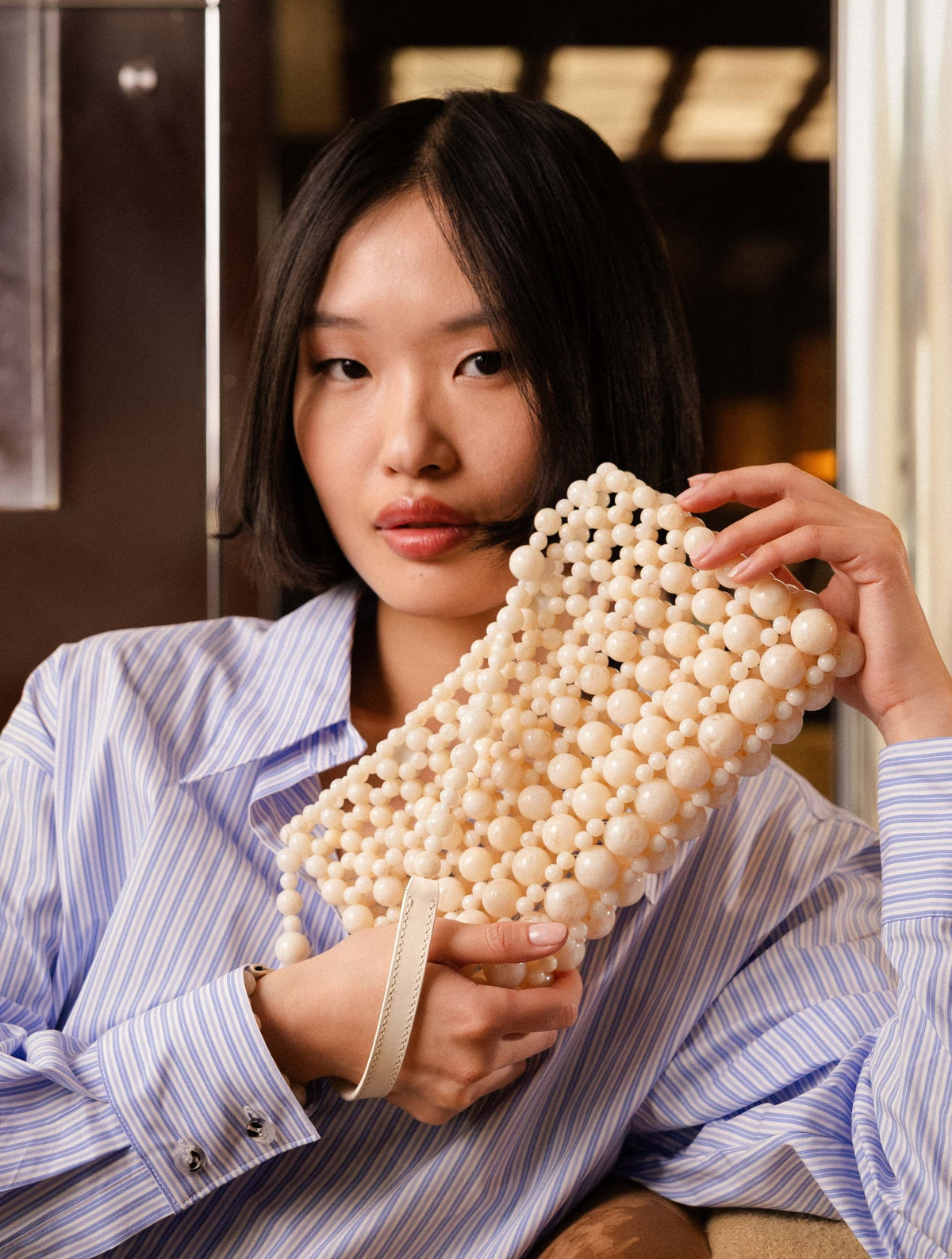 Bobbies Deià Ivory handbag — styled view
